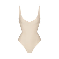 SKIMS BODY UNLINED PLUNGE THONG BODYSUIT | SAND